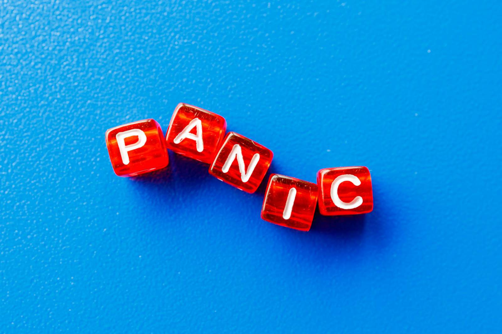 Panic - word spelled with red cubes on blue background